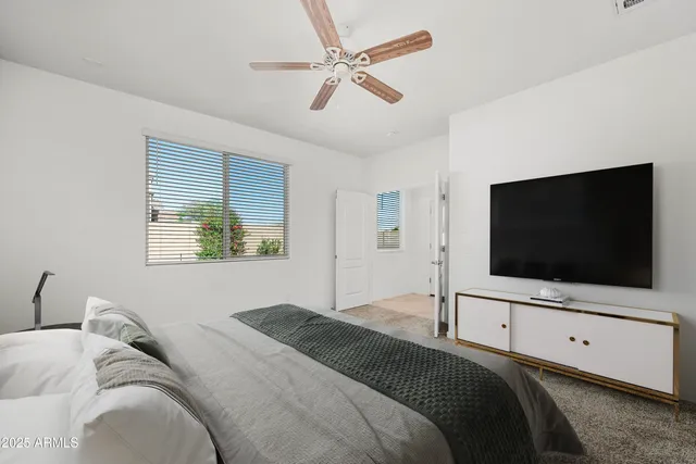 a bedroom with a bed and a flat screen tv