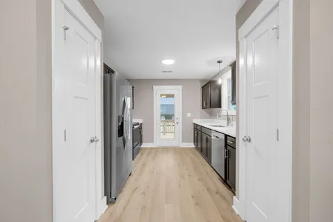 a view of a kitchen from the hallway