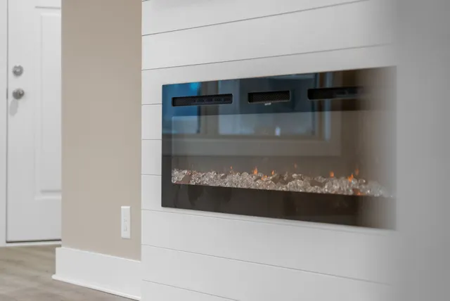 a view of an empty room with a ceiling fan window and a ceiling fan