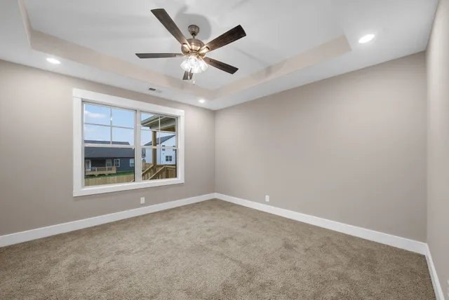 an empty room with closet and windows