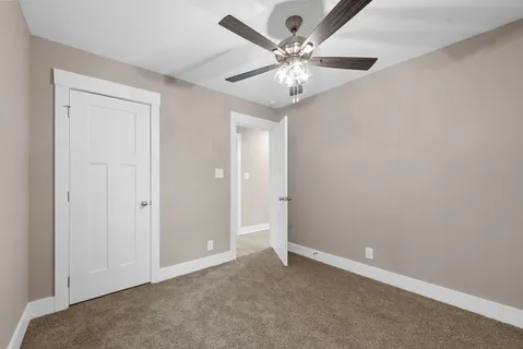 a bathroom with a granite countertop sink toilet a large mirror a bathtub and shower