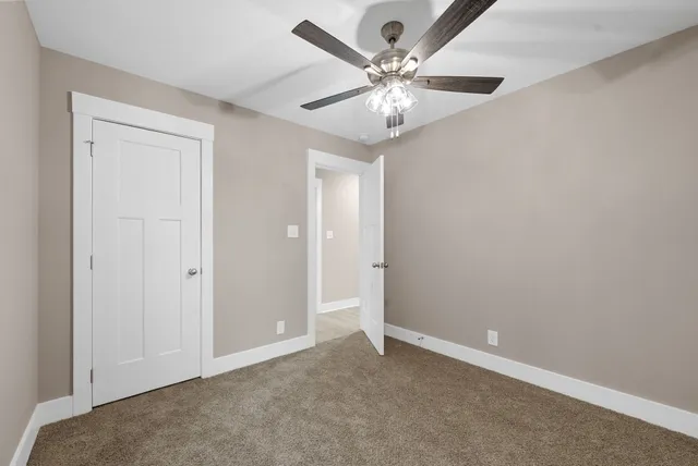 a bathroom with a granite countertop sink toilet a large mirror a bathtub and shower