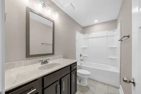 an empty room with a window and a ceiling fan