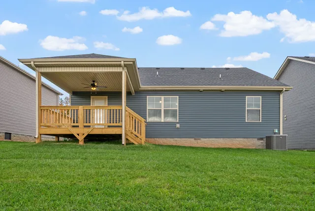 a view of a house with a big yard and large trees