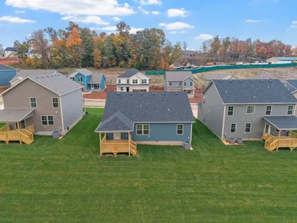 a aerial view of a house with a yard and a fountain