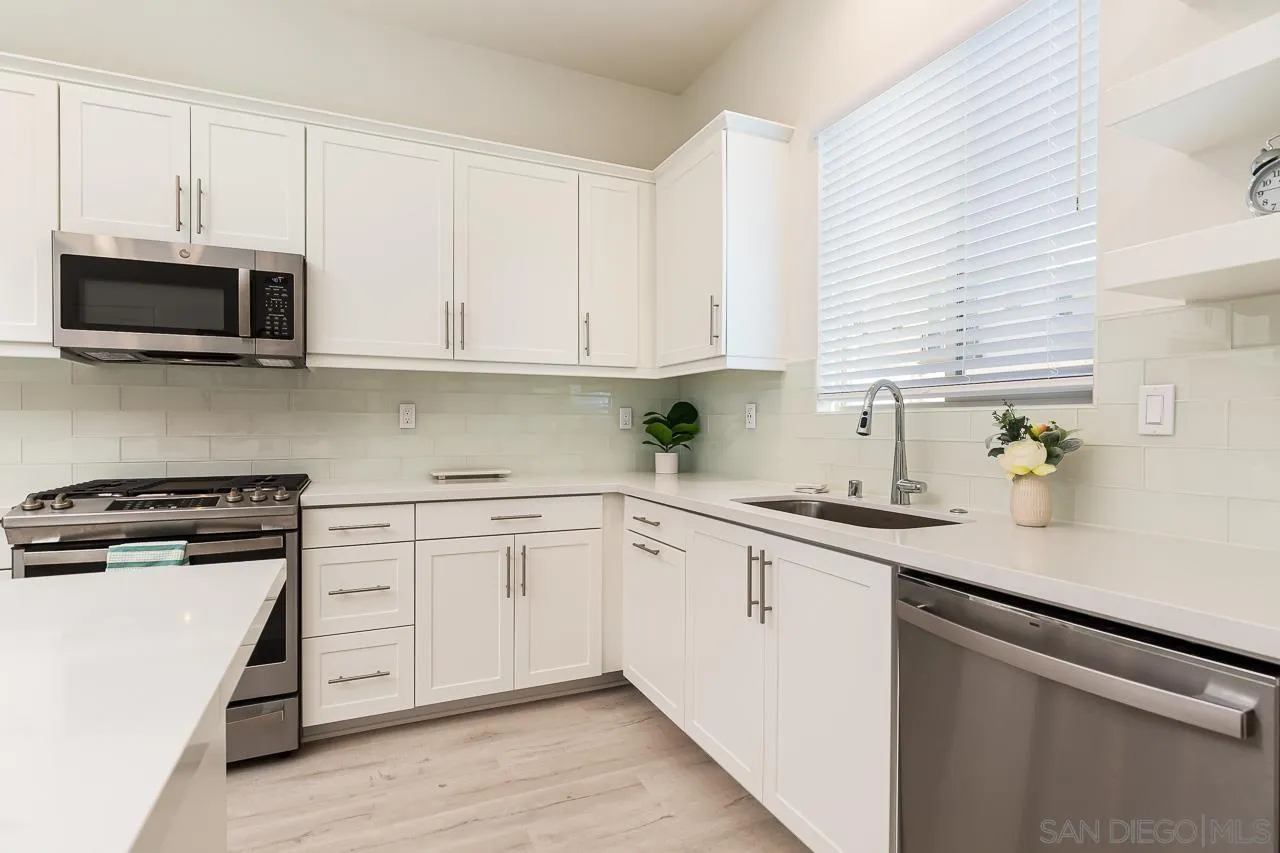 597 Townsend Way San Marcos, CA 92078 - Photo 11 of 30 a kitchen with stainless steel appliances granite countertop white cabinets a sink and a stove