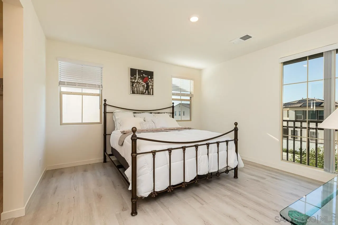 597 Townsend Way San Marcos, CA 92078 - Photo 17 of 30 a view of a bedroom with furniture window and wooden floor