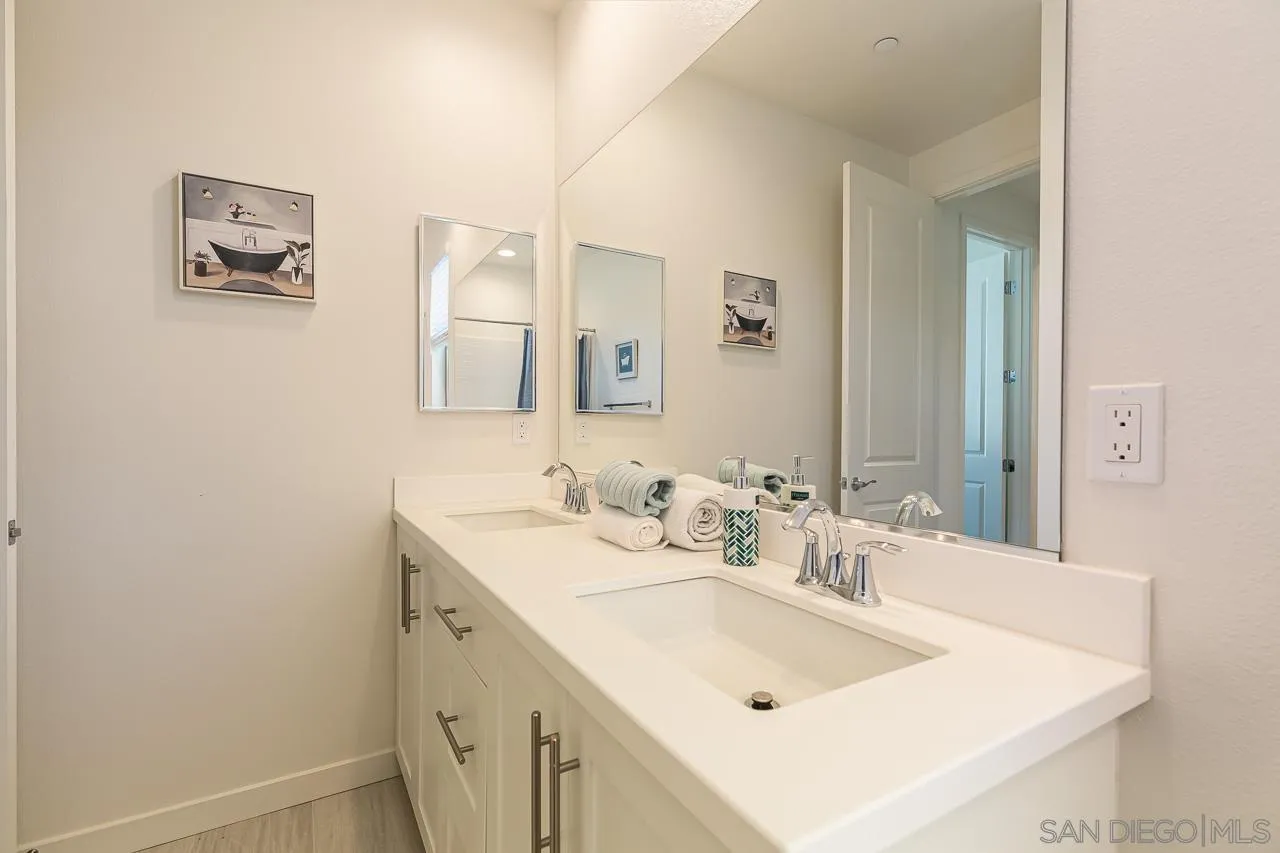 597 Townsend Way San Marcos, CA 92078 - Photo 21 of 30 a bathroom with a sink and a mirror