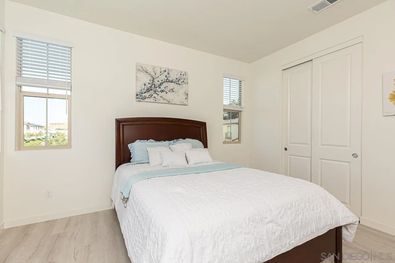 597 Townsend Way San Marcos, CA 92078 - Photo 25 of 30 a bedroom with a large bed and a window