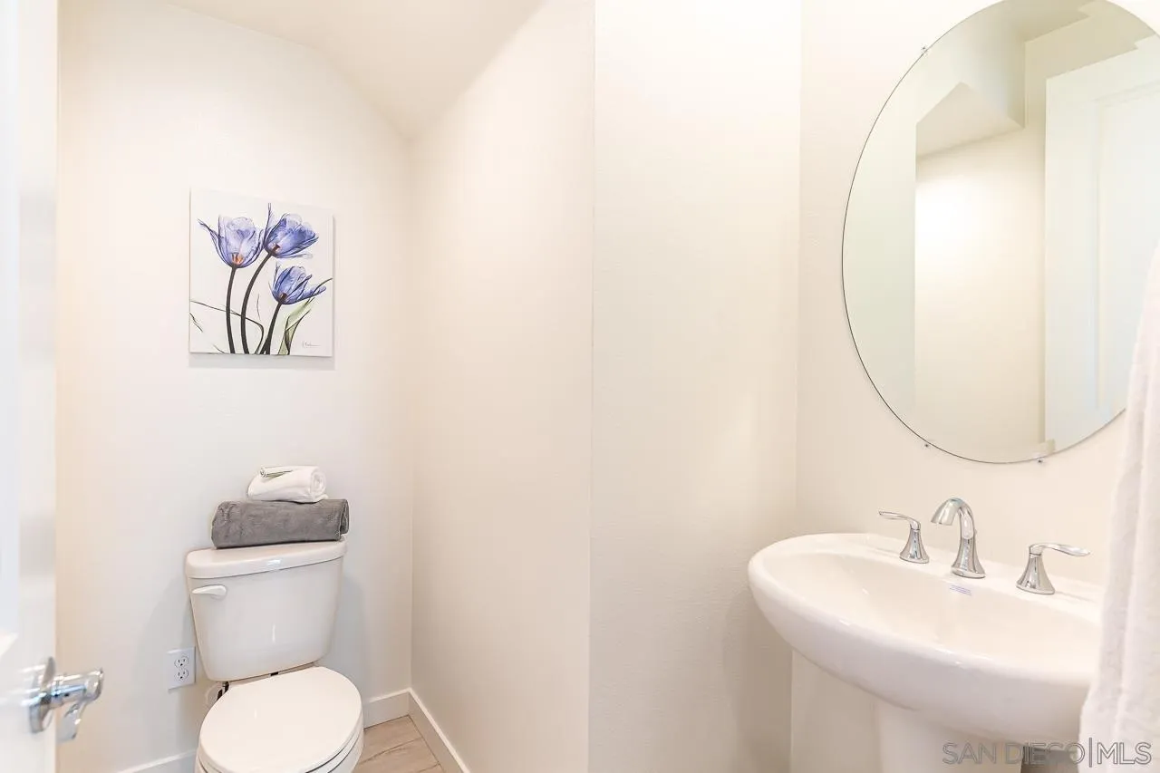 597 Townsend Way San Marcos, CA 92078 - Photo 8 of 30 a bathroom with a toilet sink vanity and mirror