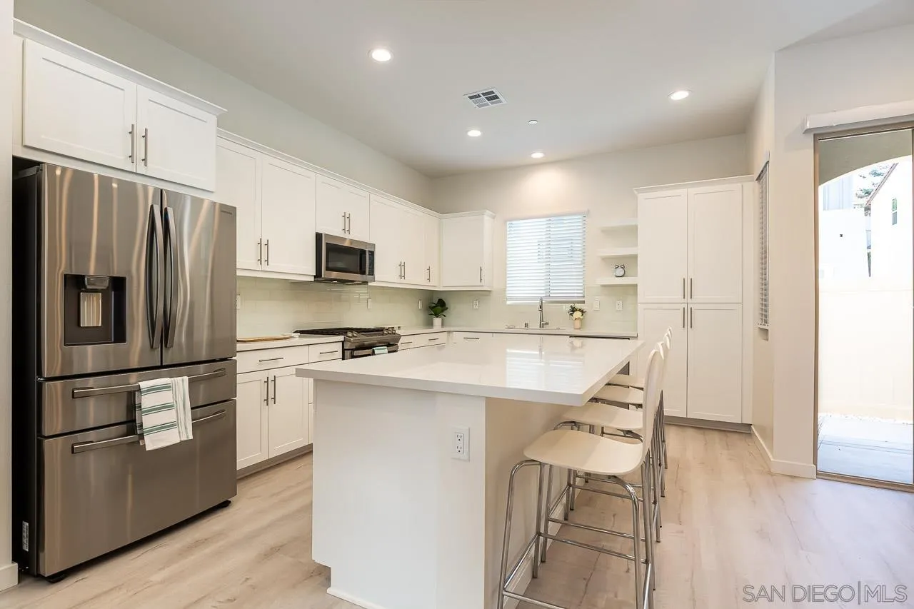 597 Townsend Way San Marcos, CA 92078 - Photo 9 of 30 a kitchen with stainless steel appliances granite countertop a refrigerator and a stove top oven
