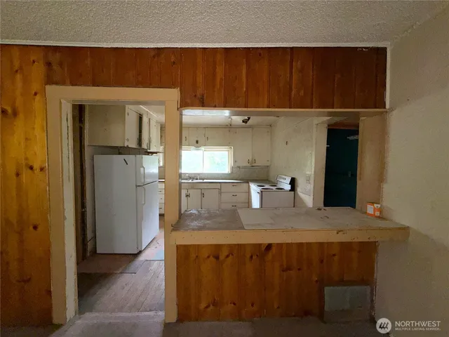 a kitchen with a refrigerator and cabinets