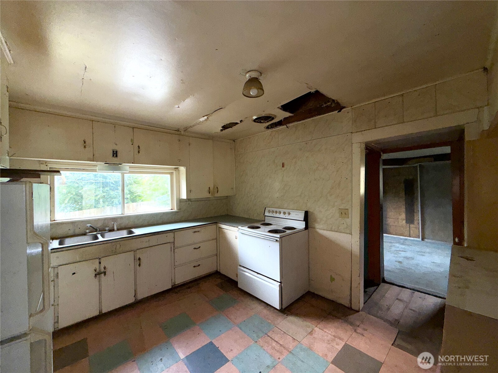 653 East 9th Street Republic, WA 99166 - Photo 12 of 23 a kitchen with stainless steel appliances a sink stove and cabinets