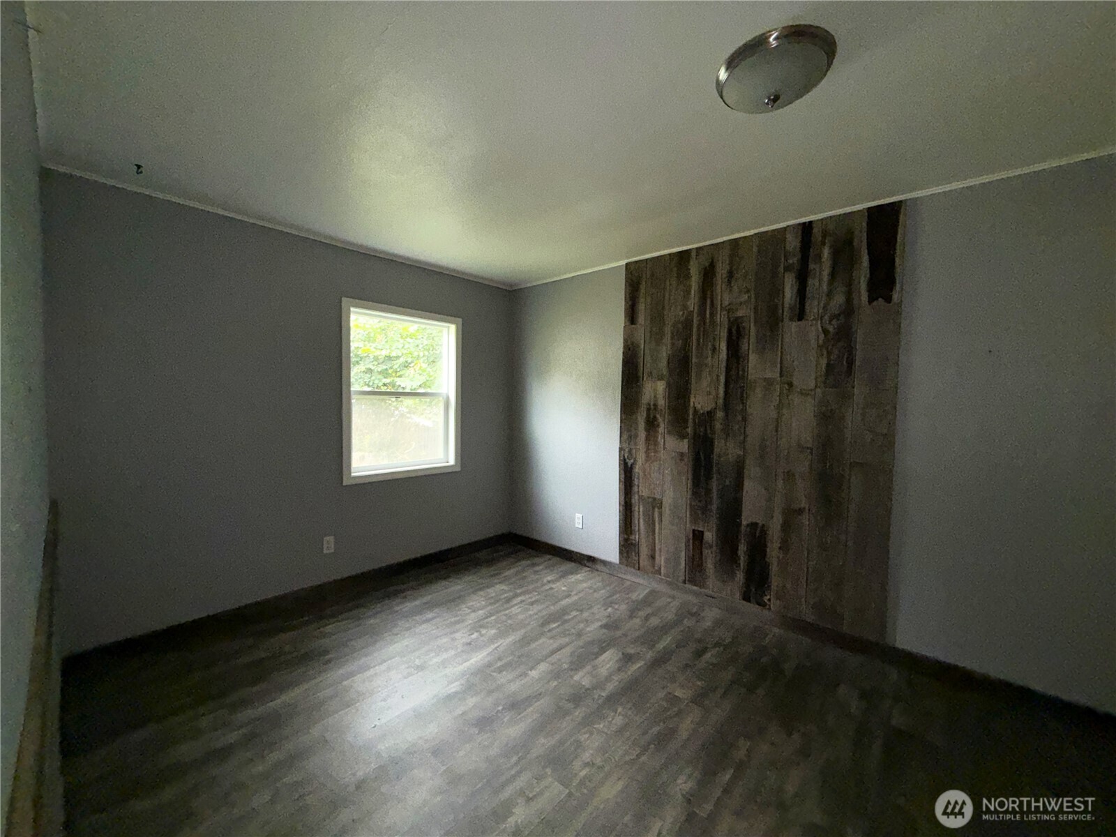 653 East 9th Street Republic, WA 99166 - Photo 13 of 23 an empty room with wooden floor and windows