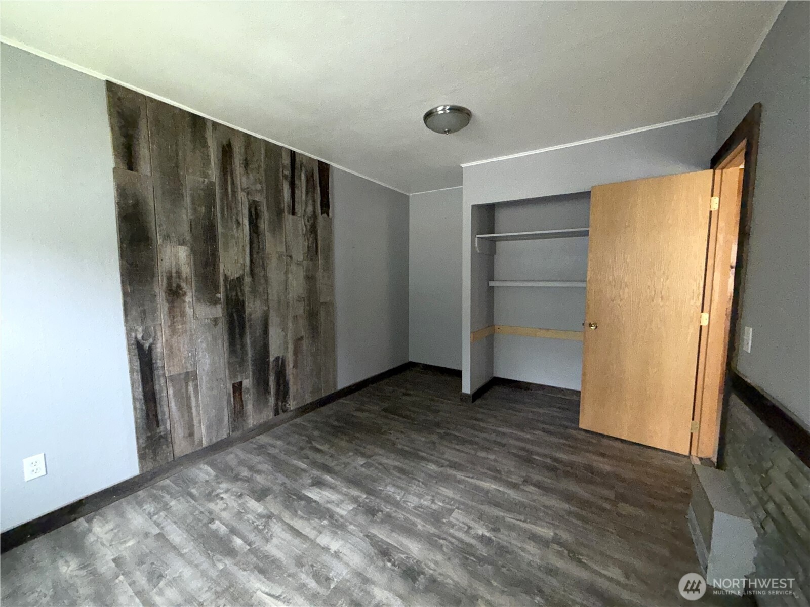 653 East 9th Street Republic, WA 99166 - Photo 14 of 23 a view of an empty room with wooden floor and a window