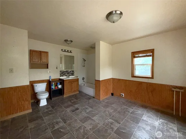 a large bathroom with a large tub and sink