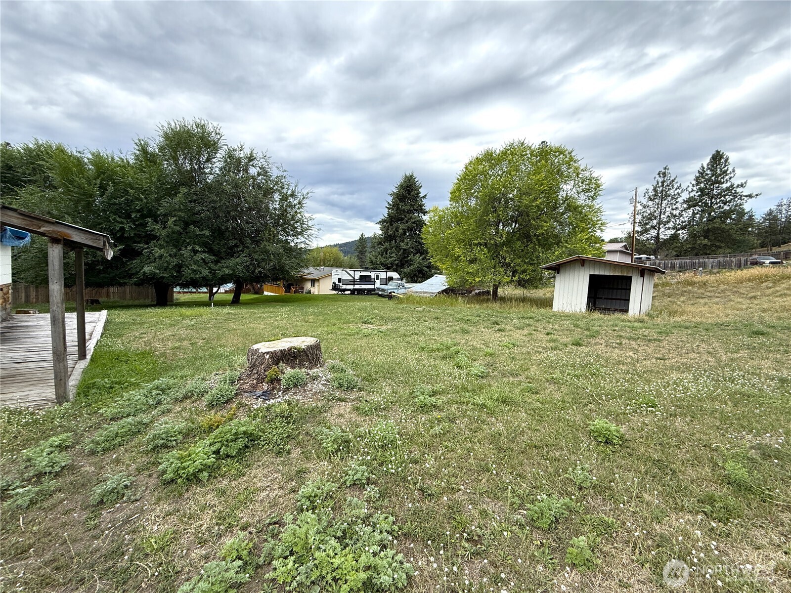 653 East 9th Street Republic, WA 99166 - Photo 2 of 23 a backyard of a house with lots of green space and garden