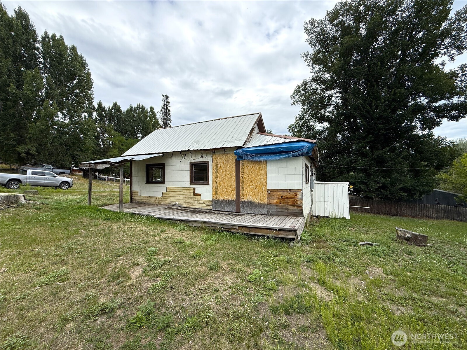 653 East 9th Street Republic, WA 99166 - Photo 5 of 23 a white house sitting in the middle of a yard