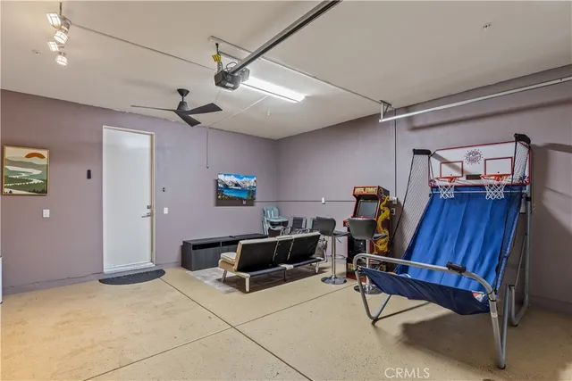 a living room with furniture a ceiling fan and a rug