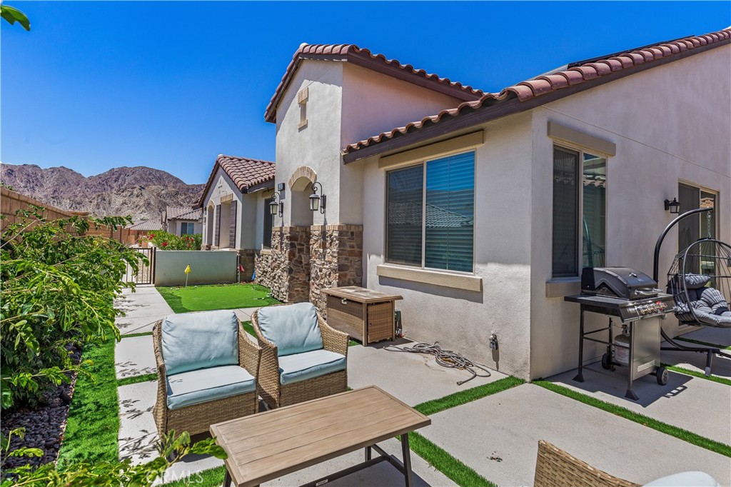 80281 Redstone Way La Quinta, CA 92253 - Photo 16 of 21 a view of a patio with couches table and chairs and potted plants