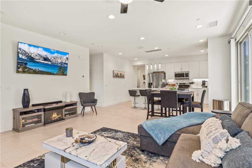 80281 Redstone Way La Quinta, CA 92253 - Photo 2 of 21 a living room with furniture and a dining table with kitchen view