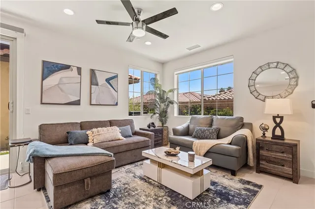 a living room with furniture a rug and a window