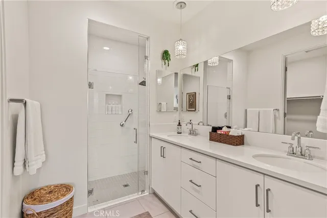 a bathroom with a double vanity sink mirror double and shower