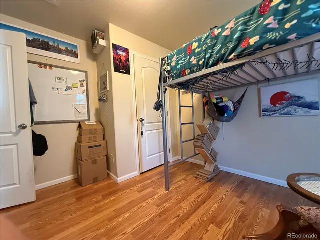 a view of a hallway with wooden floor and entryway