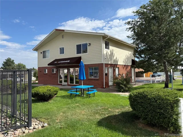 a front view of a house with a yard table and chairs