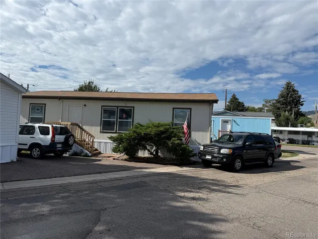 a car parked in front of white house