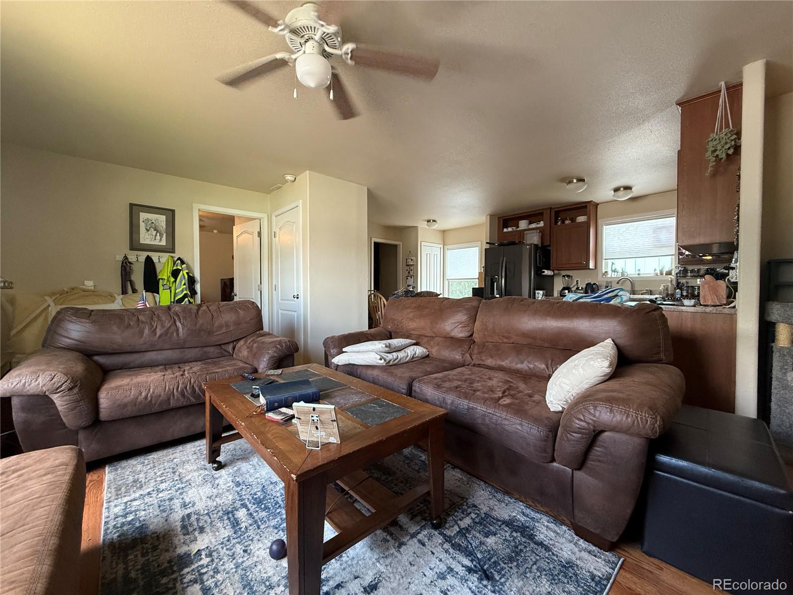 17190 Mt Vernon Road Golden, CO 80401 - Photo 3 of 21 a living room with furniture a rug and a chandelier
