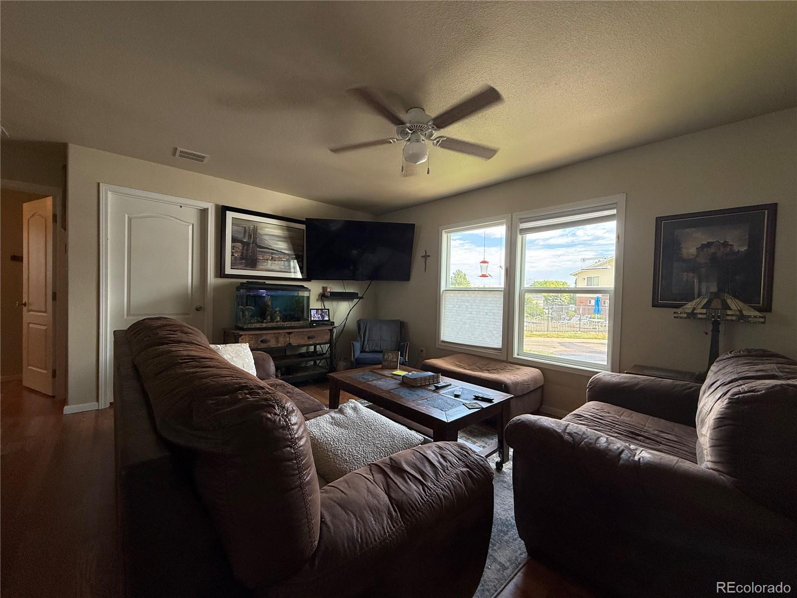 17190 Mt Vernon Road Golden, CO 80401 - Photo 5 of 21 a living room with furniture a flat screen tv and a window