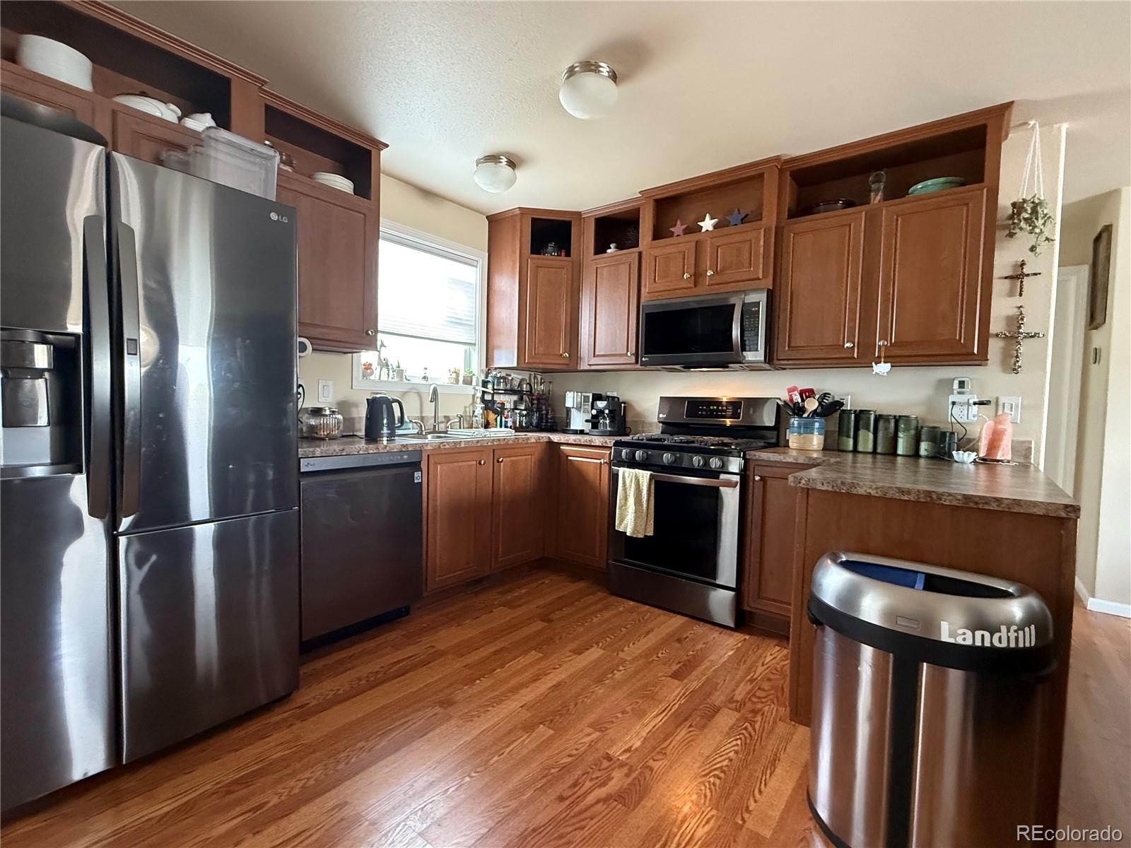 17190 Mt Vernon Road Golden, CO 80401 - Photo 7 of 21 a kitchen with stainless steel appliances granite countertop a refrigerator a sink a stove and oven