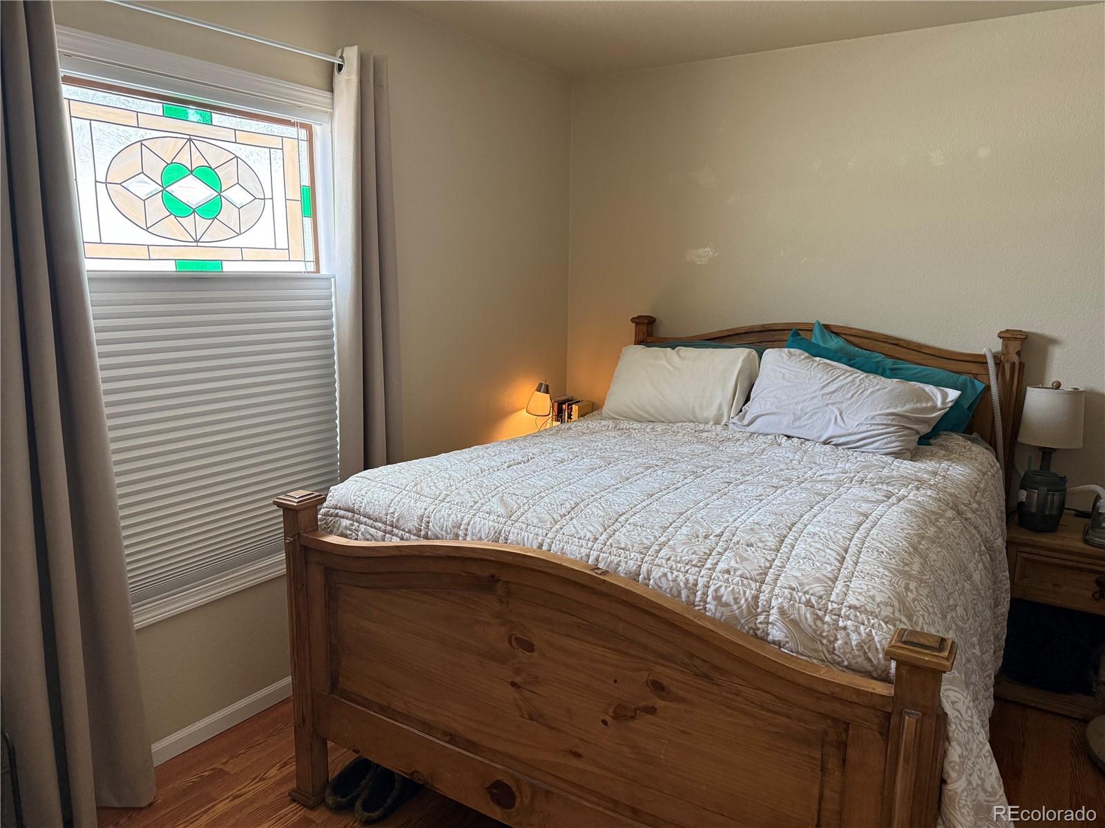 17190 Mt Vernon Road Golden, CO 80401 - Photo 9 of 21 a bedroom with a bed and a window