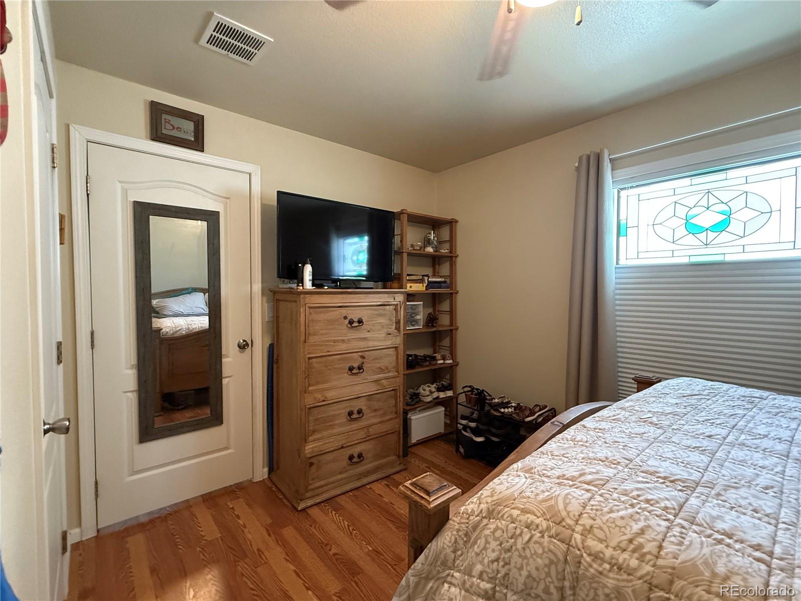 17190 Mt Vernon Road Golden, CO 80401 - Photo 10 of 21 a bedroom with a bed and a television