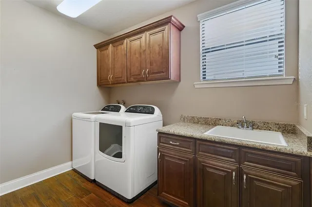 a utility room with a sink dryer and washer