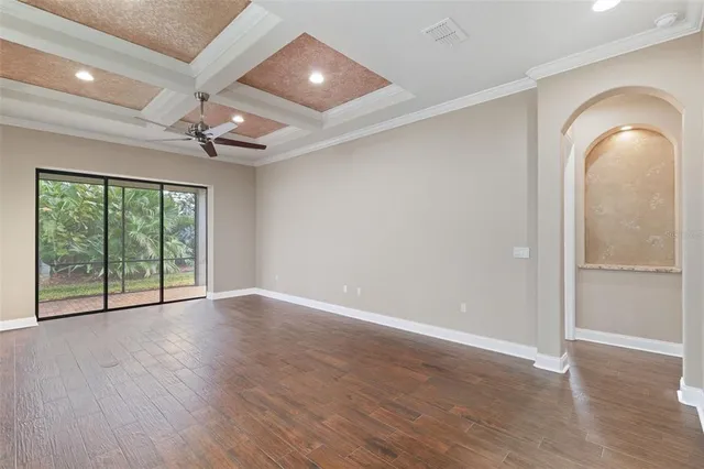 wooden floor in an empty room with a window