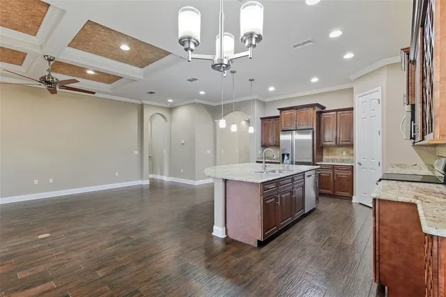 a large kitchen with stainless steel appliances granite countertop a large center island and a sink