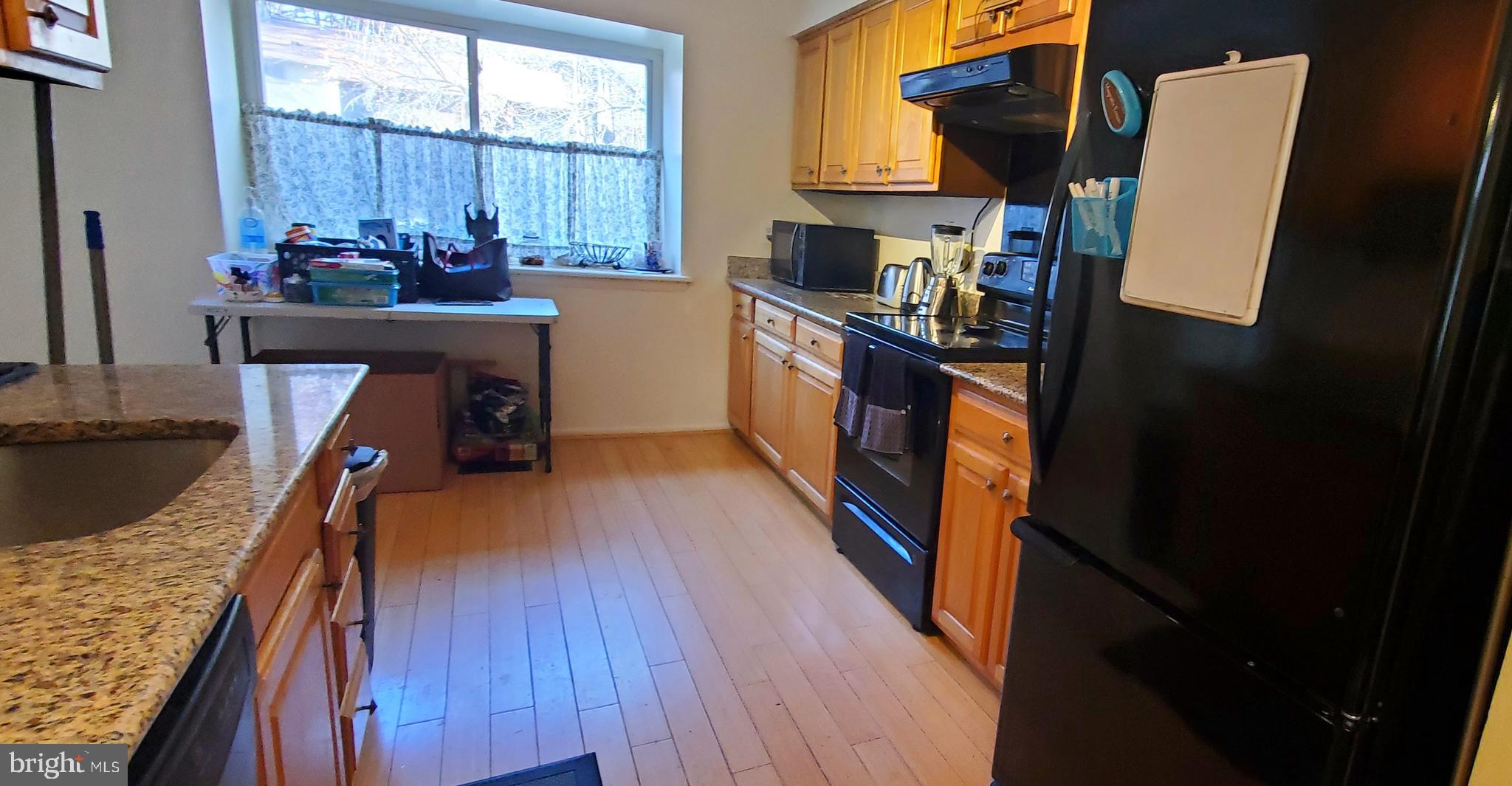 11712 Decade Court Reston, VA 20191 - Photo 3 of 18 HARDWOOD FLOORING IN KITCHEN AND BIG WINDOW