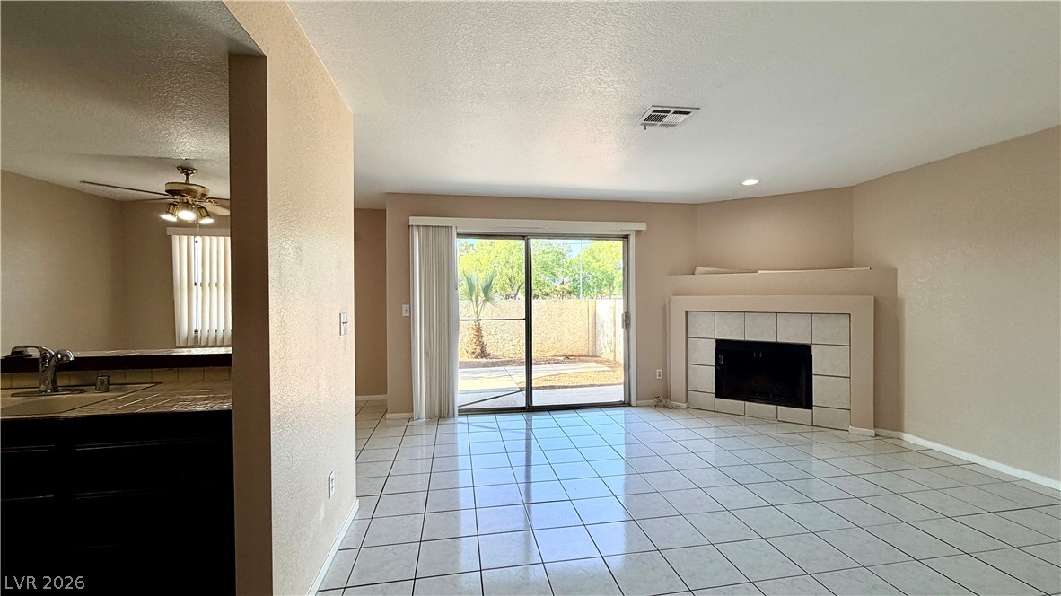 6250 West Flamingo Road, Unit 4 Las Vegas, NV 89103 - Photo 11 of 45 This bright living space features a cozy fireplace and convenient access to the backyard.