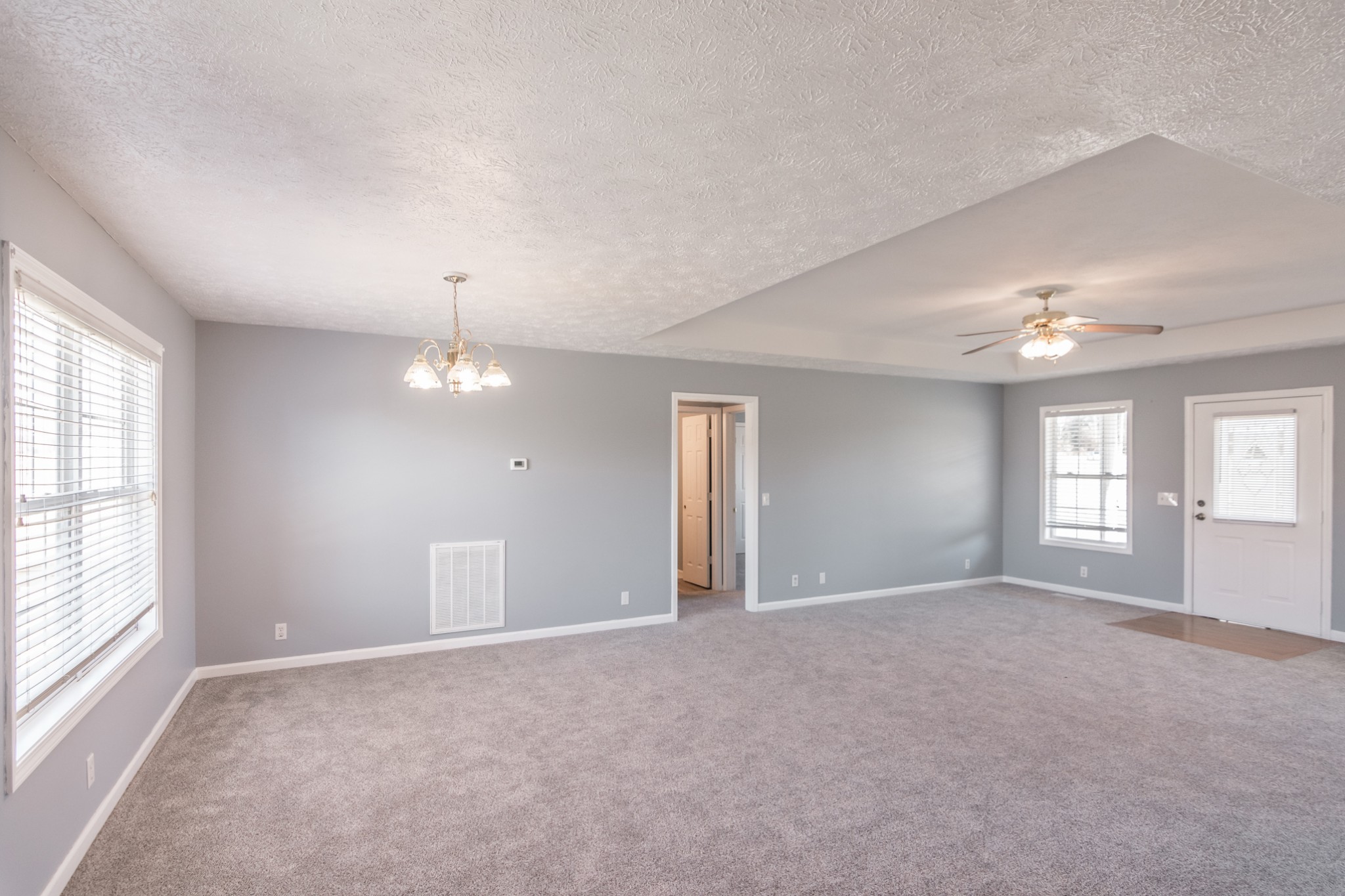 361 Corinth Road Portland, TN 37148 - Photo 13 of 46 an empty room with windows and chandelier fan