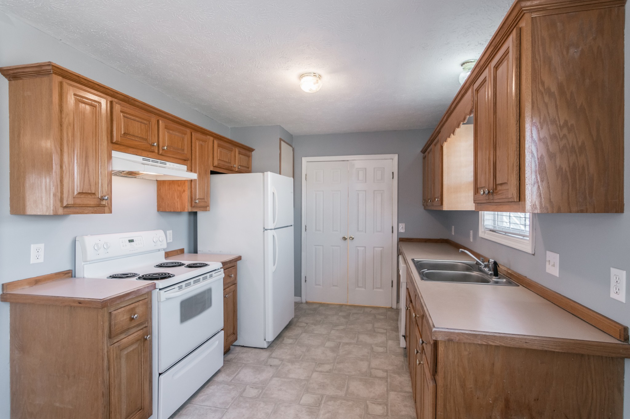 361 Corinth Road Portland, TN 37148 - Photo 15 of 46 a kitchen with a sink a refrigerator and cabinets