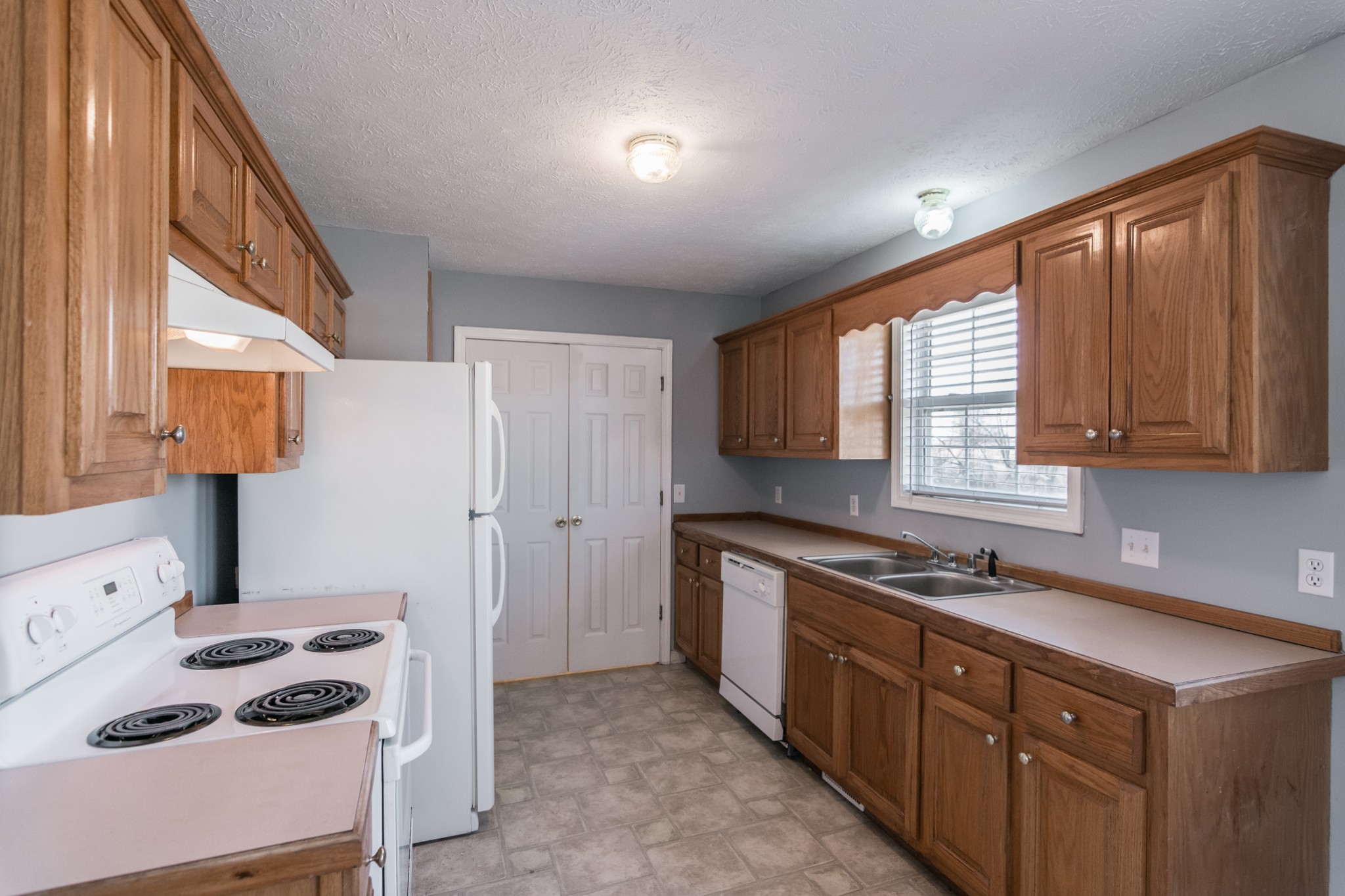 361 Corinth Road Portland, TN 37148 - Photo 16 of 46 a kitchen with a stove a sink and a refrigerator