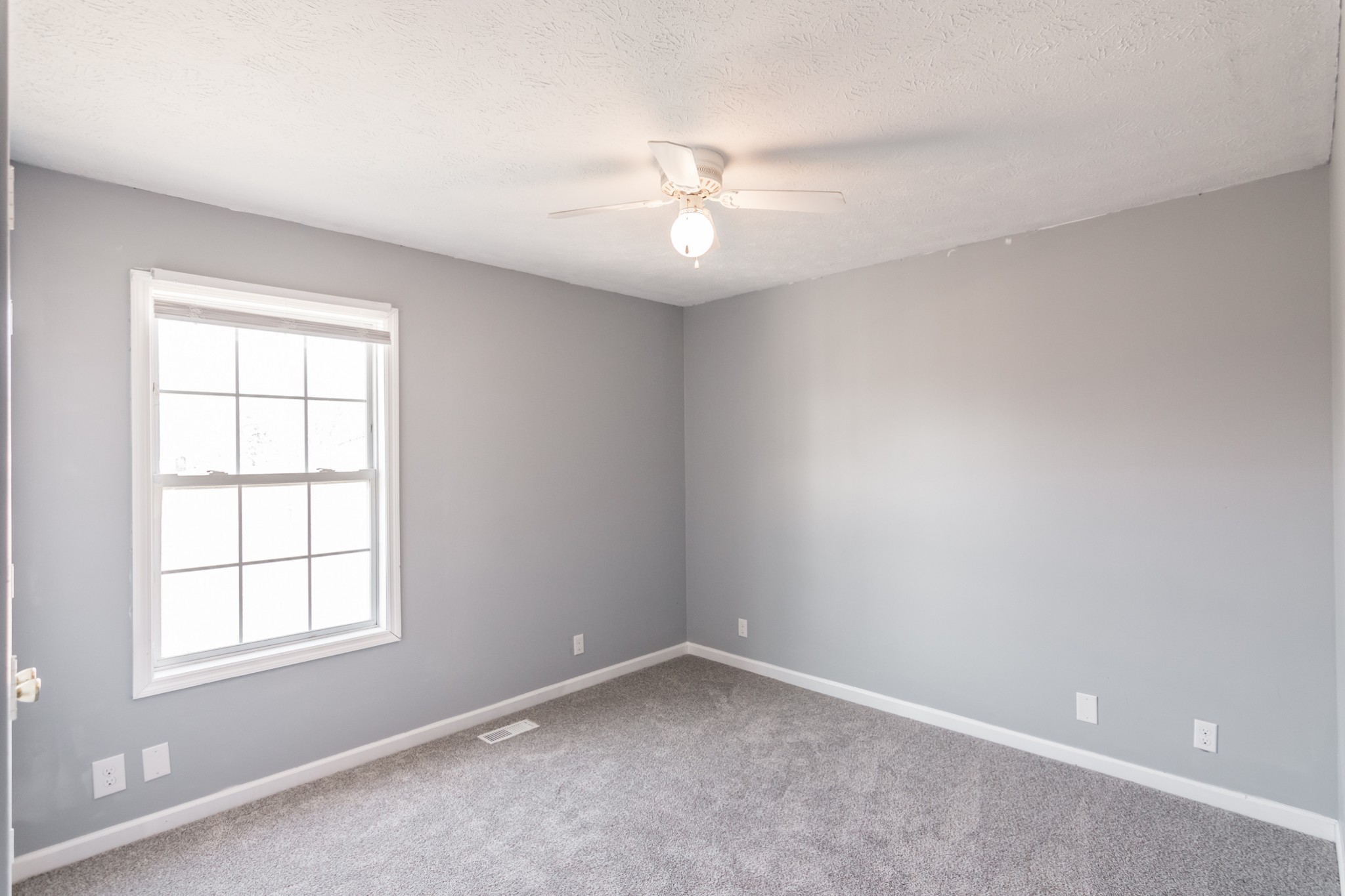 361 Corinth Road Portland, TN 37148 - Photo 33 of 46 an empty room with a window and ceiling fan