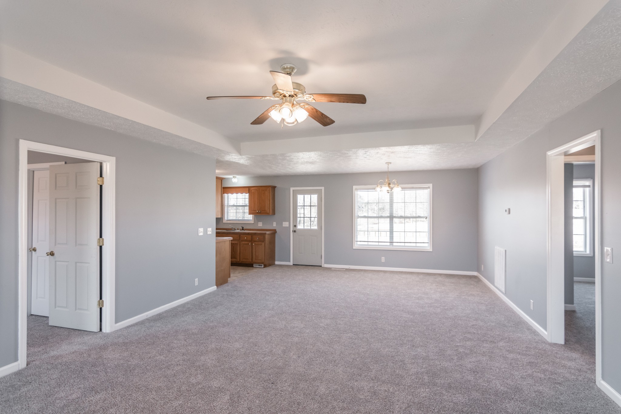 361 Corinth Road Portland, TN 37148 - Photo 7 of 46 a view of a big room with windows and chandelier fan