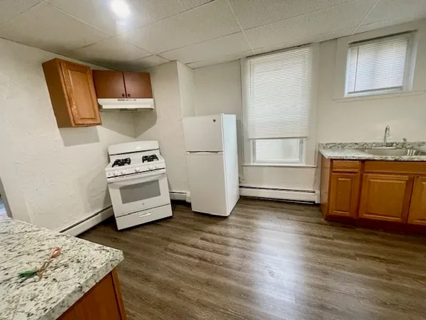 a kitchen with stainless steel appliances a stove a refrigerator and cabinets