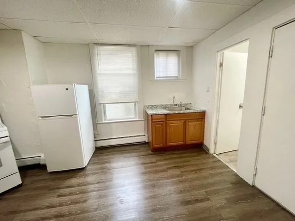 a room with a refrigerator and a stove