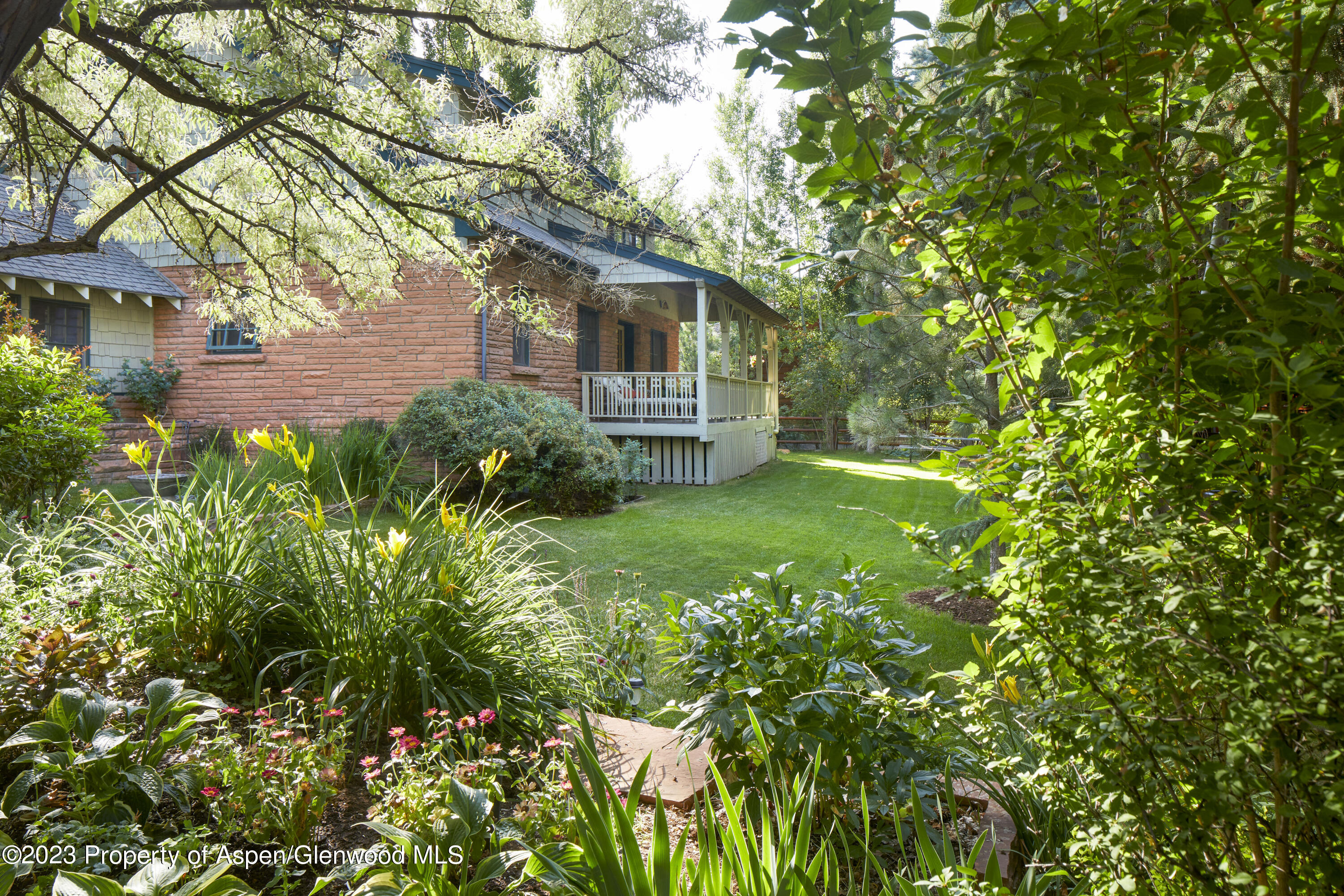 135 Riverside Drive Basalt, CO 81621 - Photo 15 of 18 a backyard of a house with plants and large trees