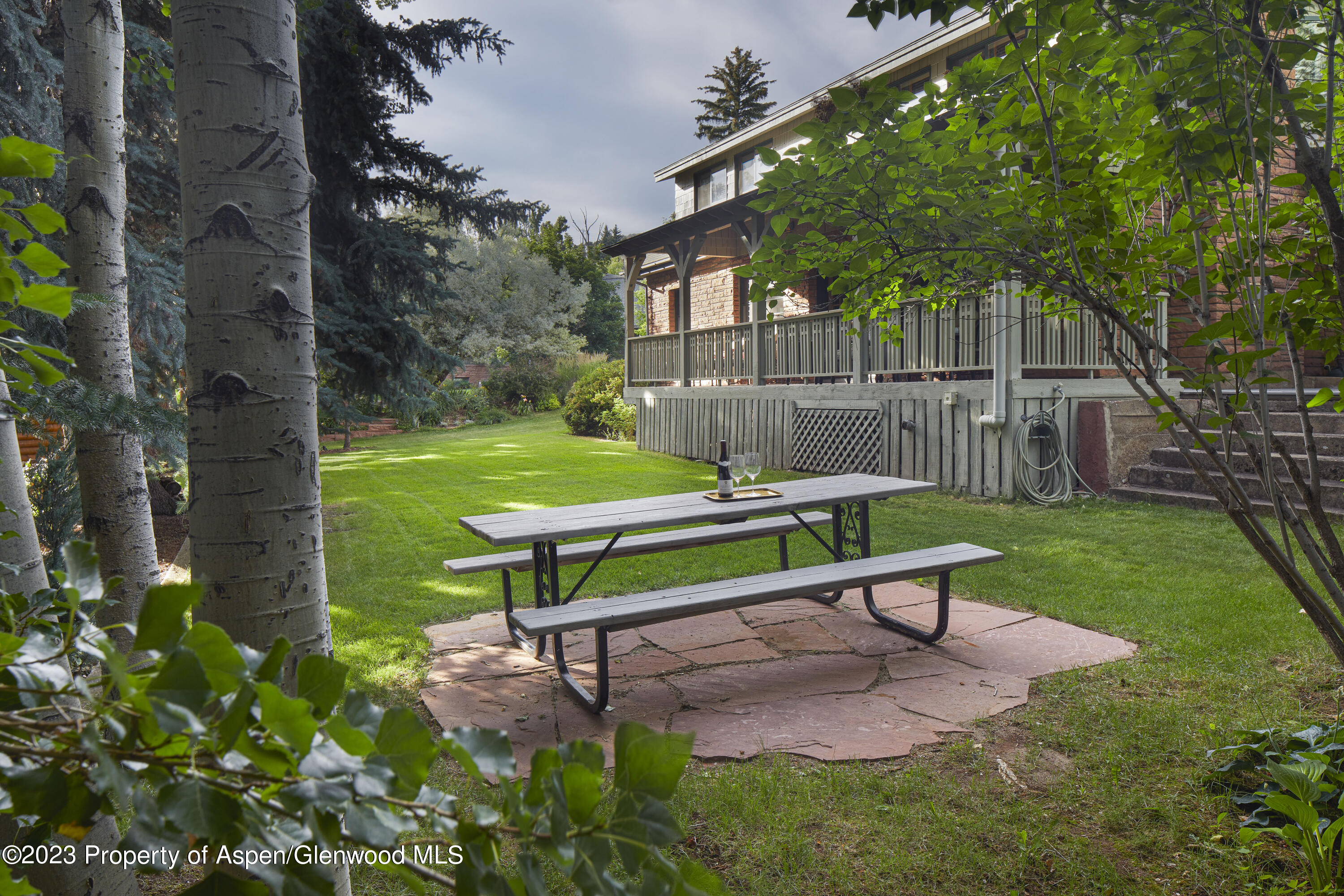 135 Riverside Drive Basalt, CO 81621 - Photo 17 of 18 a green bench sitting in the middle of a park
