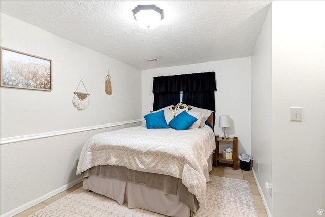 5321 South 3100th Street West Roy, UT 84067 - Photo 43 of 64 Bedroom featuring tile flooring, white walls, and a chair rail molding